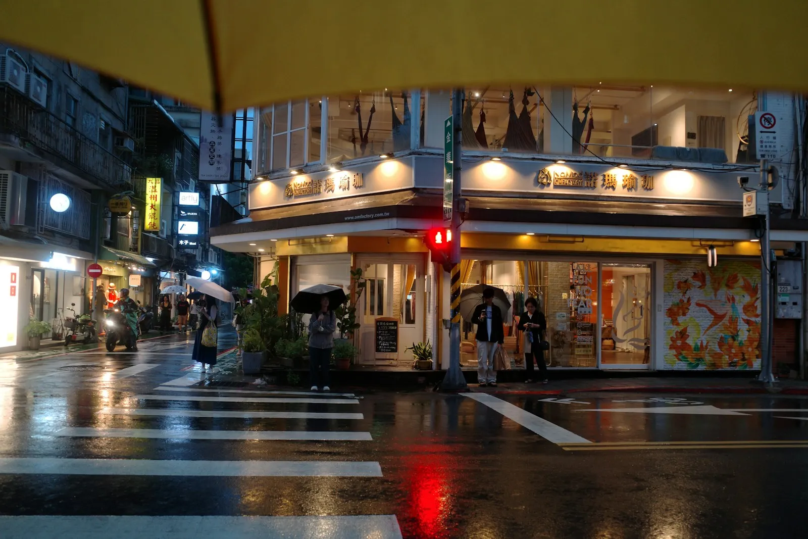 A rainy street with shop windows glowing in Taipei
