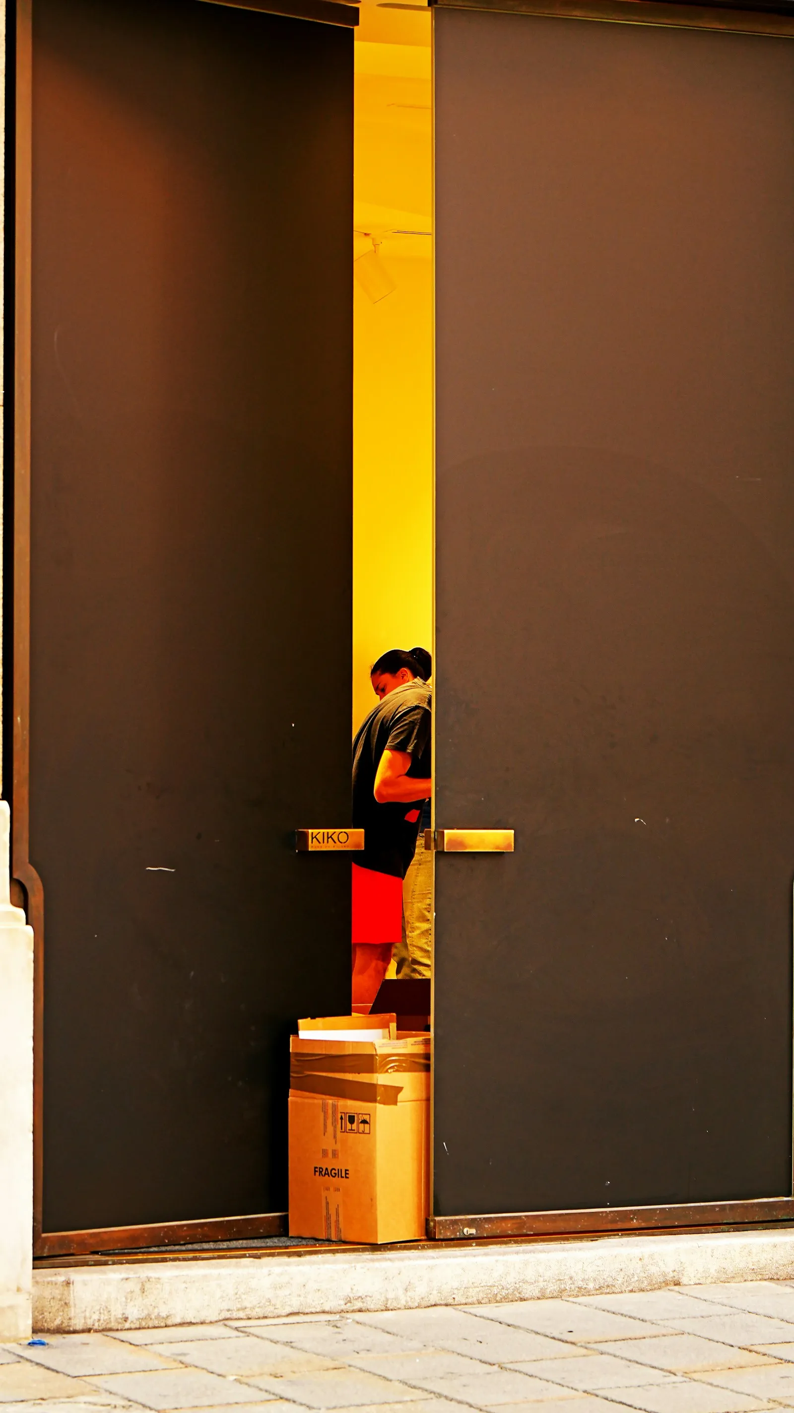 A cardboard parcel waiting by a doorway